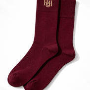 Pair of burgundy socks with a logo on a white background