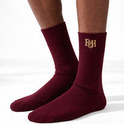 Maroon socks with a logo on a white background