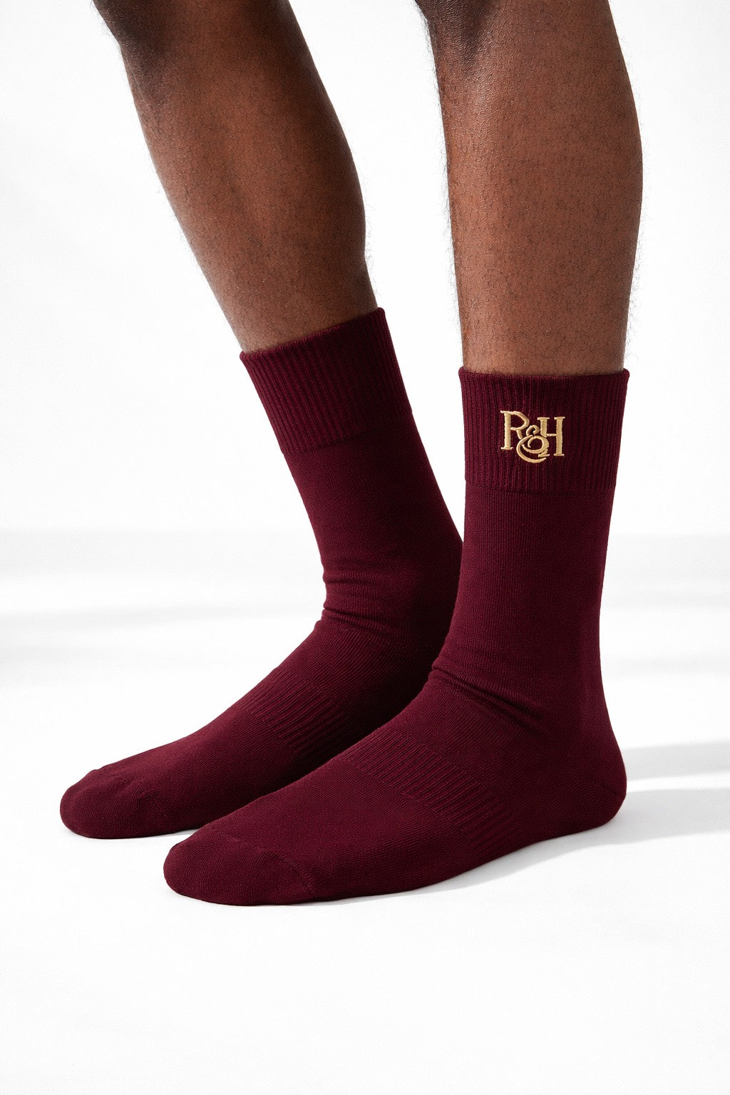 Maroon socks with a logo on a white background