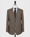 A brown and beige houndstooth patterned blazer displayed on a mannequin torso, styled with a brown tie and a blue-and-white striped shirt against a light gray background.