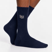 Navy socks with a logo on the leg against a white background