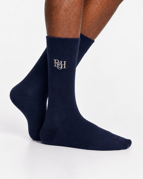 Navy socks with a logo on the leg against a white background