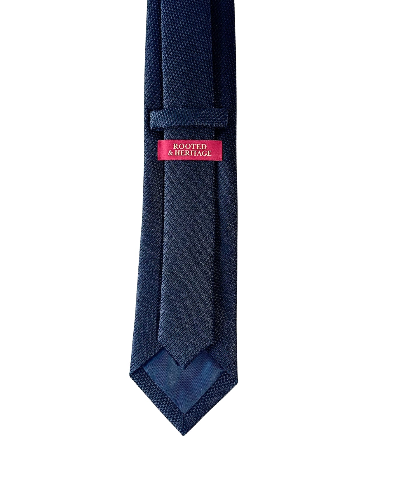 Navy blue tie with a pink label on a white background