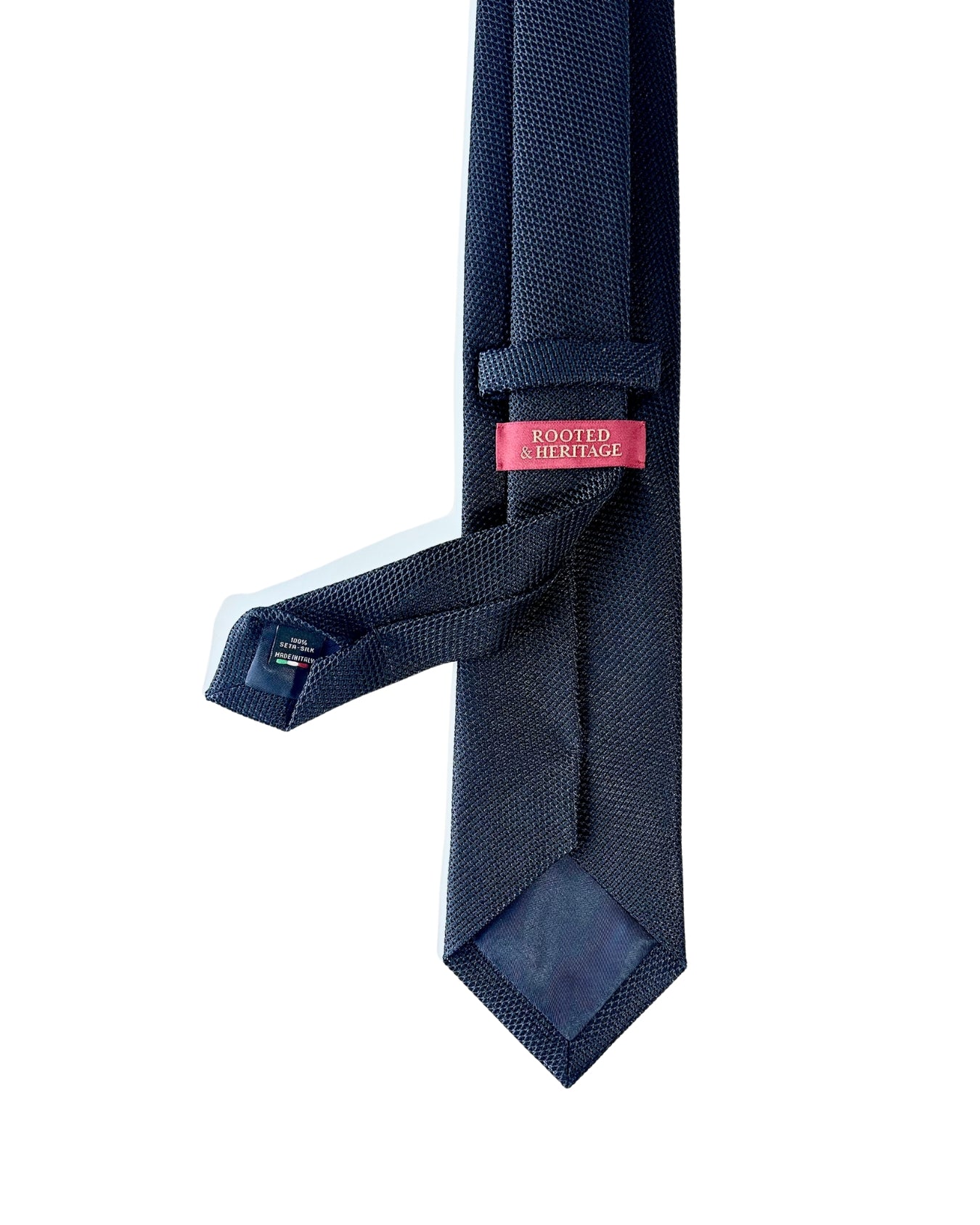 Navy textured tie with a pink label on a white background