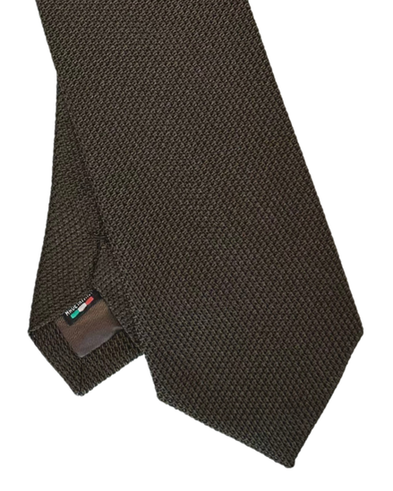 A close-up of a dark brown textured necktie with a small brand tag visible near the tip, set against a plain white background.