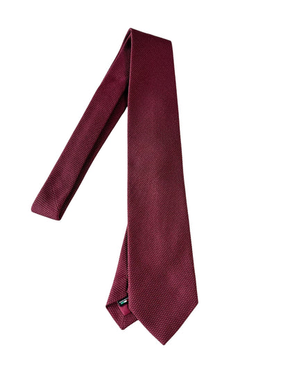 Maroon tie on a white background
