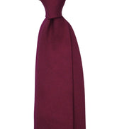 Maroon tie on a white background