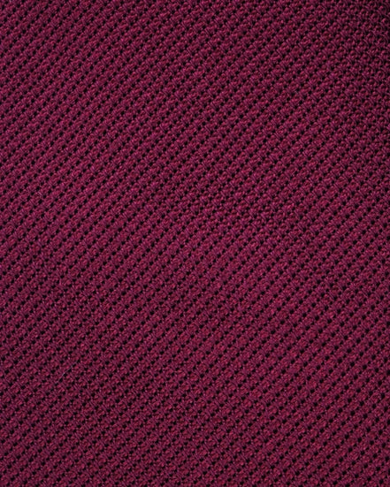 Close-up of a textured purple fabric with a diagonal pattern